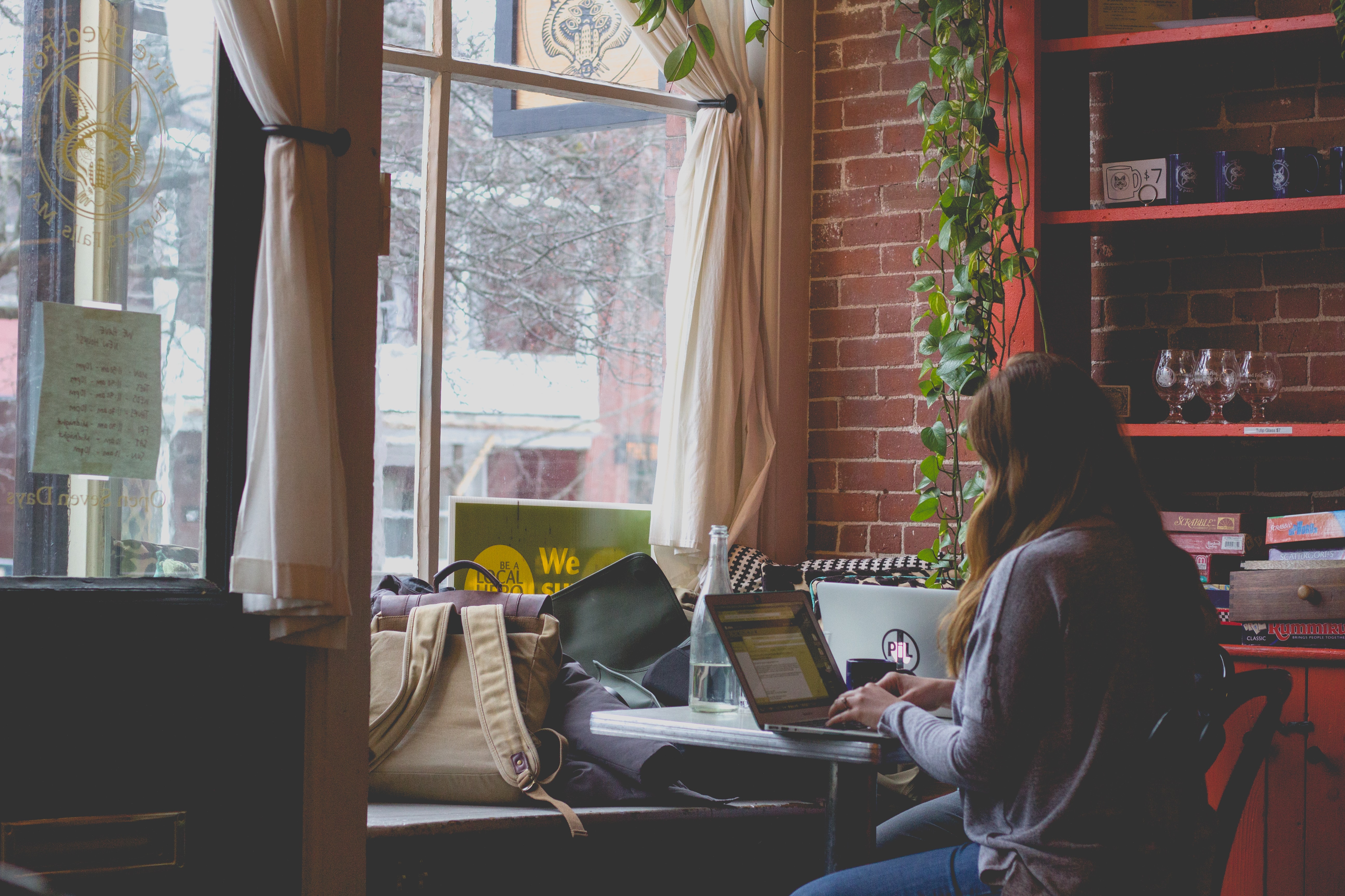 working on a laptop in a cafe